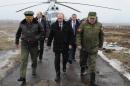 Russian President Vladimir Putin, center, and Defense Minister Sergei Shoigu, left, and the commander of the Western Military District Anatoly Sidorov, right, walk upon arrival to watch military exercise near St.Petersburg, Russia, Monday, March 3, 2014. Putin has sought and quickly got the Russian parliament's permission to use the Russian military in Ukraine.(AP Photo/RIA-Novosti, Mikhail Klimentyev, Presidential Press Service)