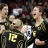 FILE - In this Dec. 13, 2012, file photo, Oregon's Canace Finley, left, Katherine Fischer (12) and Liz Brenner (6) celebrate a second game victory over Penn State in the national semifinals of the NCAA college women's volleyball tournament in Louisville, Ky. Brenner figures she's only in college once, she might as well play the sports she loves. And for the Oregon sophomore, that's volleyball, basketball, softball and track and field — although not at once. (AP Photo/Garry Jones, File)