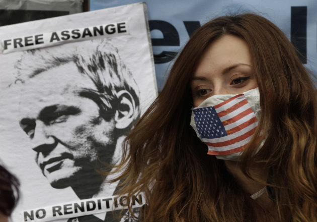 A supporter of WikiLeaks founder Julian Assange sits outside the Ecuadorian Embassy, in London, Friday, June 22, 2012. Assange entered the embassy on Monday in an attempt to gain political asylum to p