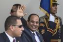 Egyptian President Abdel Fattah al-Sisi waves as he arrives for the opening ceremony of a new waterway at the Suez Canal on August 6, 2015, in the port city of Ismailiya