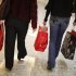 Shoppers carry their purchases during the Black Friday sales at a shopping mall in Tysons Corner