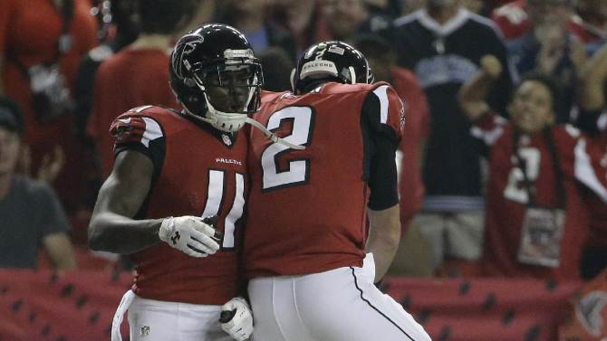 Atlanta Falcons wide receiver Julio Jones (11) celebrates his touchdown with Atlanta Falcons quarterback Matt Ryan (2) during the second half of an NFL football game against the Tampa Bay Buccaneers, Thursday, Sept. 18, 2014, in Atlanta