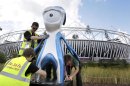 Workmen position a Mandeville official Paralympic mascot as preparations are made at the Olympic Park ahead of the 2012 Paralympics, Tuesday, Aug. 28, 2012, in London. The Paralympics will start with the opening ceremony on Aug. 29. (AP Photo/Kirsty Wigglesworth)