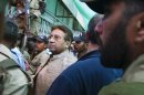Pakistan's former President and military ruler Pervez Musharraf, center, arrives in an anti-terrorism court in Islamabad, Pakistan on Saturday, April 20, 2013. The general who ruled Pakistan for nearly a decade before being forced to step down appeared Saturday in front of an anti-terrorism court in connection with charges linked to his 2007 sacking and detention of a number of judges. (AP Photo/Anjum Naveed)