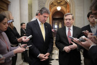 Sen. Joe Manchin, D-WV, left, and Sen. Mark Kirk, R-Ill., comment as the Senate approves legislation that extends Social Security payroll tax cuts for two months, at the Capitol in Washington. The action also extends long-term unemployment benefits for another two months and forces President Barack Obama to approve construction of a controversial oil pipeline. (AP Photo/J. Scott Applewhite)