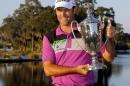 Robert Streb holds the trophy after winning a three-way playoff during the final round of the McGladrey Classic golf tournament on Sunday, Oct. 26, 2014, in St. Simons Island, Ga. Streb beat Brednon de Jonge, of Zimbabwe, and Will MacKenzie. (AP Photo/Stephen B. Morton)