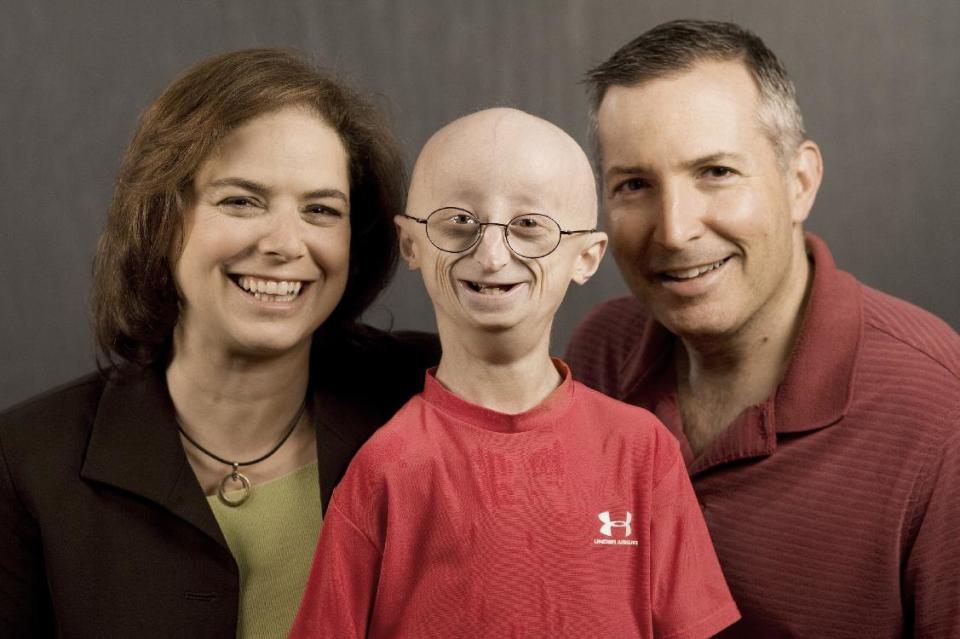 This undated photo provided by HBO shows Sam Berns, the subject of the HBO documentary, &quot;Life According to Sam,&quot; center, with his parents, Leslie Gordon, left, and Scott Berns. Sam Berns, 17, died Friday, Jan. 10, 2014 of complications from Hutchinson-Gilford progeria syndrome, commonly known as progeria. Hundreds of people, including New England Patriots owner Robert Kraft, attended his funeral on Tuesday, Jan. 14, 2014. (AP Photo/HBO, Sean Fine)