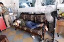 A Free Syrian Army fighter rests in a shop in Aleppo's al-Zebdieh district