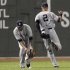 New York Yankees right fielder Jones bobbles a ball hit by Boston Red Sox's Pedroia after Yankees teammate Jeter dropped it during the first inning of American League MLB baseball action at Fenway Park in Boston