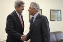 Defense Secretary Chuck Hagel, right, welcomes Secretary of State John Kerry, left, to his office at the Pentagon in Washington, Monday, May 6, 2013. Hagel invited Kerry to the Pentagon for a working lunch to discuss a range of national security issues. (AP Photo/Susan Walsh)