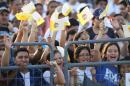 A group of young people wave flags representing the colors of Vatican City as they wait for the arrival of Pope Francis at Samanes Park in Guayaquil, Ecuador, Monday, July 6, 2015. Hours before Francis arrives in Ecuador's port city of Guayaquil, thousands are already waiting in Samanes Park where the pope is expected to celebrate Mass with up to 1 million people. (AP Photo/Fernando Vergara)