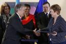 U.N. High Commissioner for Refugees Guterres shakes hands with European Commissioner Georgieva after signing contracts between the European Union and the United Nations on humanitarian support to Syria, in Brussels