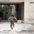 In this Tuesday, Nov. 6, 2012 photo, a Syrian rebel runs for cover to avoid Syrian Army sniper fire on Sabaa al- ahriat street, in the Old City of Aleppo, Syria.(AP Photo/Monica Prieto)