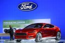 A man passes the Ford Evos concept car at the Washington Auto Show