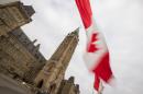 A Canadian flag flies in front of the peace tower on Parliament Hill in Ottawa, Canada on December 4, 2015