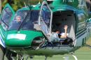 Brazilian striker Neymar waves on July 5, 2014 from inside the helicopter that will transport him from Teresopolis, Rio de Janeiro State, Brazil to his residence in Guaruya