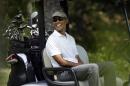 FILE - In this Aug. 15, 2015 file photo, President Barack Obama smiles as he sits in a cart while golfing at Farm Neck Golf Club, in Oak Bluffs, Mass., on the island of Martha's Vineyard. So far, one rainy day is the only thing that has dampened President Barack Obama's two-week summer vacation on Martha's Vineyard. Chunky text look at vacation. (AP Photo/Steven Senne, File)