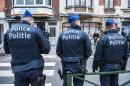 Three police officers stand guard at the Meiser neighbourhood in Schaarbeek - Schaerbeek in Brussels on March 25, 2016 during an anti-terrorist operation searching for suspects of the March 22 terrorist attacks in Brussels