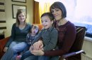 Jeana Bonner, left, of South Jordan, Utah, and Rebecca Preece from Nampa, Idaho, sit with their adopted children at a hotel in Moscow, Russia, Saturday, Feb. 9, 2013. After weeks of anxiety, plodding through the opaque Russian legal system and suffering wallet-thinning expenses, two U.S. women have custody of their adopted Russian children and are preparing to take them home to start a new life together. (AP Photo/Mikhail Metzel)