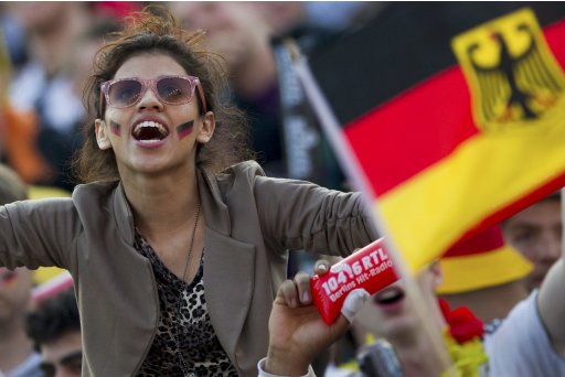 A Germany supporter reacts as she watches Germany play Portugal during Euro 2012 soccer match at the Fan Mile in Berlin