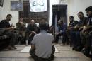 Local commanders and members of Aleppo's most important rebel unit, the Liwa al-Tawhid brigade, gather for a daily meeting in their headquarters in Izaa neighborhood of Aleppo on September 25, 2012