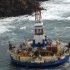 In this image provided by the U.S. Coast Guard the conical drilling unit Kulluk sits grounded 40 miles southwest of Kodiak City, Thursday, Jan. 3, 2012. The Kulluk grounded after many efforts by tug vessel crews and Coast Guard crews to move the vessel to safe harbor during a winter storm.Calls for federal scrutiny of Royal Dutch Shell PLC drilling operations in Arctic waters swelled Thursday with a request for a formal investigation by members of Congress. (AP Photo/U.S. Coast Guard, Petty Officer 2nd Class Zachary Painter)