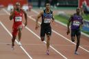 Asafa Powell of Jamaica, left, runs to win the men's 100m event with Jimmy Vicaut of France who set the European record, center, and Kim Collins of the Federation of Saint Christopher and Nevis, right, at the IAAF Diamond League athletics meeting at Stade de France stadium in Saint Denis north of Paris, France, Saturday July 4, 2015. (AP Photo/Michel Euler)