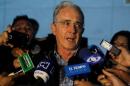 Colombian former president and Senator Alvaro Uribe talks to the media after a meeting with Colombia's President Santos at military air base in Rionegro, Colombia