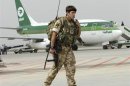 A British soldier walks near an Iraqi Airways plane, during handover ceremony of Basra's international airport from British forces to the U.S. forces