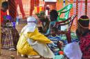 An MSF medical worker feeds an Ebola child victim at an MSF facility in Kailahun, on August 15, 2014