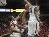 Oral Roberts' Warren Niles (13) tries to shoot over the defense of Arizona's Solomon Hill (44) and Angelo Chol (30) during the first half of an NCAA college basketball game at McKale Center in Tucson, Ariz., Tuesday, Dec. 18, 2012. (AP Photo/Wily Low)