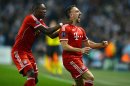 Bayern Munich's French midfielder Franck Ribery (R) celebrates scoring with Austrian defender David Alaba at The City of Manchester stadium in Manchester, northwest England, on October 2, 2013