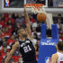 San Antonio Spurs center Tim Duncan dunks as Los Angeles Clippers forward Blake Griffin during the first half in Game 4 of an NBA basketball playoffs Western Conference semifinal, Sunday, May 20, 2012, in Los Angeles. (AP Photo/Mark J. Terrill)