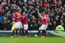 Manchester United's Chris Smalling, second left, celebrates with teammates after scoring during the English Premier League soccer match between Manchester United and Manchester City at Old Trafford Stadium, Manchester, England, Sunday, April 12, 2015. (AP Photo/Jon Super)