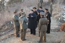 North Korean leader Kim Jong-Un talks with generals as soldiers of the Korean People's Army (KPA) take part in landing and anti-landing in the eastern sector of the front and the east coastal area
