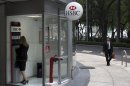 A woman uses a cash machine at the HSBC bank headquarters in Mexico City, Wednesday, July 25, 2012. Mexican regulators have levied a $28 million fine against the Mexico subsidiary of London-based HSBC bank for failing to prevent money laundering through accounts at the bank. (AP Photo)