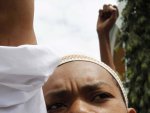 A Muslim faithful chants slogans during a protest against the killing of Sheikh Aboud Rogo Mohammed, after Friday prayers at the Masjid Musa Mosque, in Mombasa