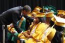 U.S. President Barack Obama comforts a student overcome with emotion after speaking with the graduating class from Booker T. Washington High School in Memphis