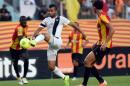 Tunisia CS Sfax striker Yassine Khnissi (C) controls the ball ahead of Esperance of Tunis player Chamseddine Dhaouadi (R) during their CAF Champions League football match on June 8, 2014 at the Olympic Stadium in the Tunisian port city of Rades