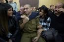 Israeli soldier Elor Azaria, who is charged with manslaughter by the Israeli military, sits to hear his verdict in a military court in Tel Aviv, Israe