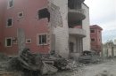 View of buildings damaged by what activists said were missiles fired by a Syrian Air Force fighter jet loyal to President Bashar al-Assad in the Akraba suburb of Damascus