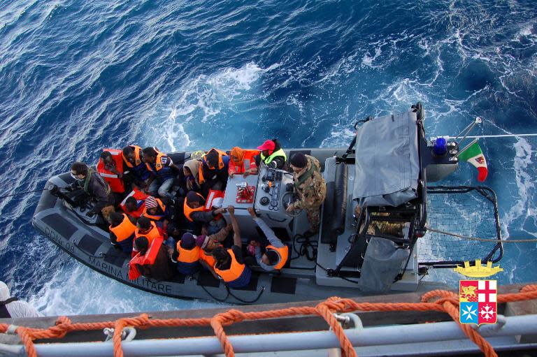 A handout picture released by the Italian Navy shows immigrants being rescued near the Italian island of Lampedusa on January 2, 2014