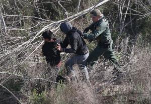 A US Border Patrol agent detains a pair juvenile undocumented &hellip;