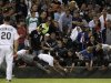 Fans reach for a foul ball during the MLB American League baseball game between Chicago White Sox and New York Yankees, in Chicago