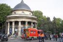 A fire truck is parked at the entrance to Monceau parc in the center of Paris, France, Saturday, May 28, 2016, after a lightning bolt crashed down onto a Paris park, striking 11 people at a child's birthday party. (AP Photo/Francois Mori)