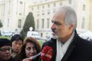 Bashar Jaafari, Syrian government's ambassador to UN and member of Syrian government delegation, speaks to journalists upon his arrival for the first meeting face-to-face with Syrian opposition delegation in Geneva