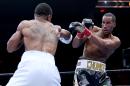 James DeGale, of England, right, blocks a punch from Andre Dirrell during a boxing match for the vacant IBF super middleweight title Saturday, May 23, 2015, in Boston. (AP Photo/Mary Schwalm)