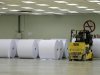 Rolls of finished paper are stored in the finishing area in pulp and paper factory in Kerinci