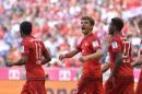 Bayern's Thomas Mueller, center, celebrates after scoring during the German Bundesliga soccer match between FC Bayern Munich and FC Augsburg in the Allianz Arena in Munich, Germany, on Saturday, Sept. 12, 2015. (AP Photo/Kerstin Joensson)