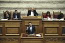 Greece's Prime Minister Alexis Tsipras, front, addresses lawmakers during a parliamentary session in Athens, Saturday, Dec. 10, 2016. Greek parliament votes on 2017 budget, as the country's left-wing government is still negotiating a new series of cost-cutting reforms that are expected to remove protection measures for private sector jobs and distressed mortgage holders. (AP Photo/Yorgos Karahalis)